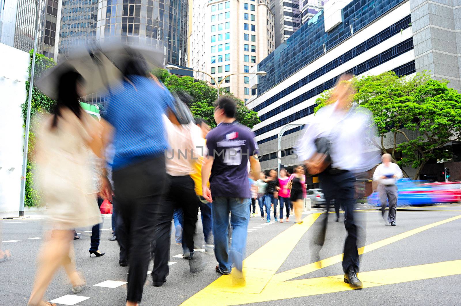 Unidentified businessmen crossing the street in Singapore. There are more than 7,000 multinational corporations from US States, Japan and Europe in Singapore 