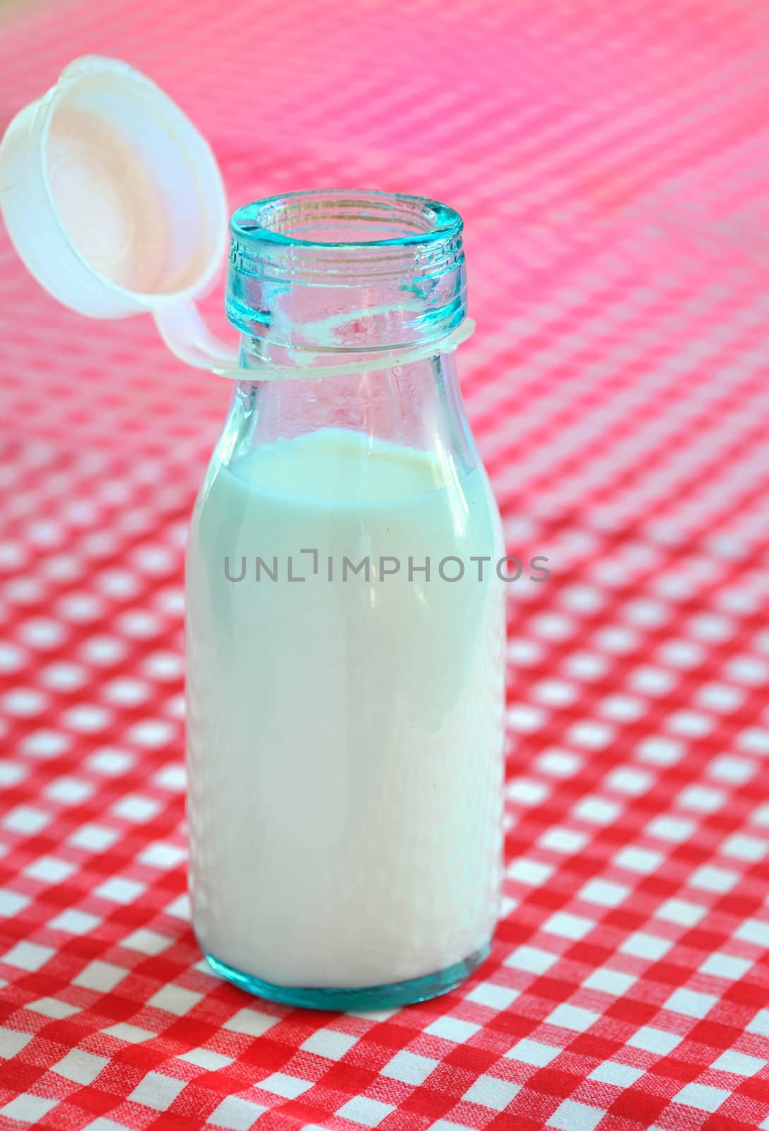 bottle of milk on table by jordachelr