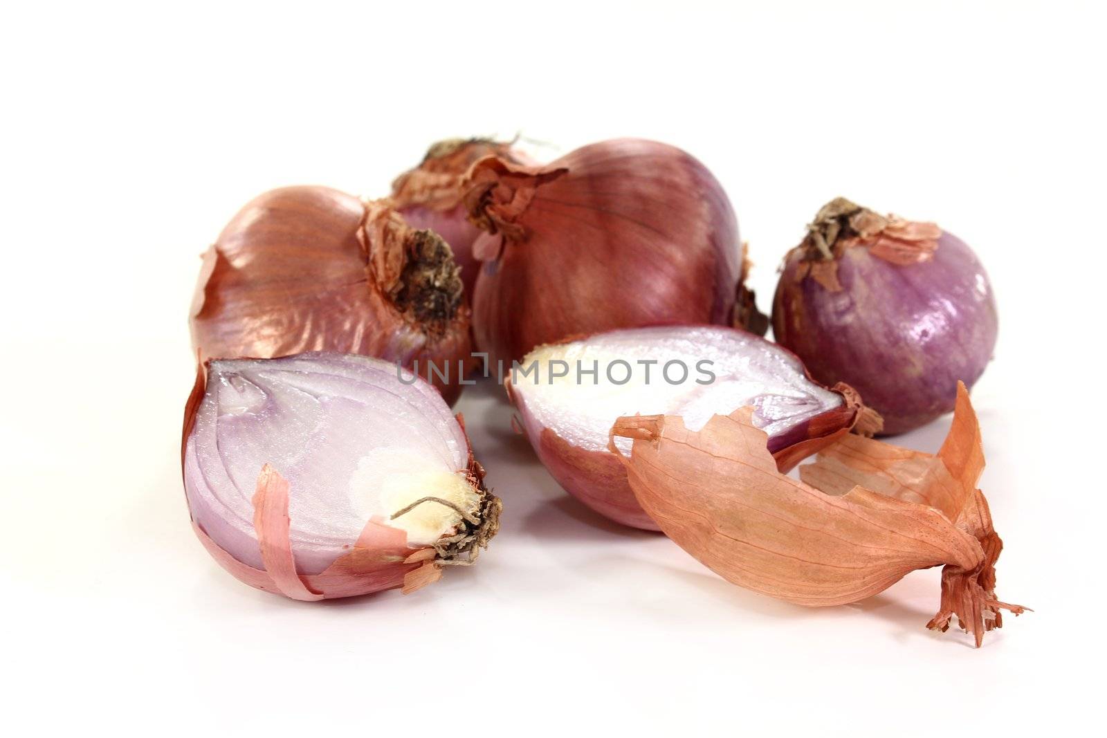 Shallots and peel on a white background