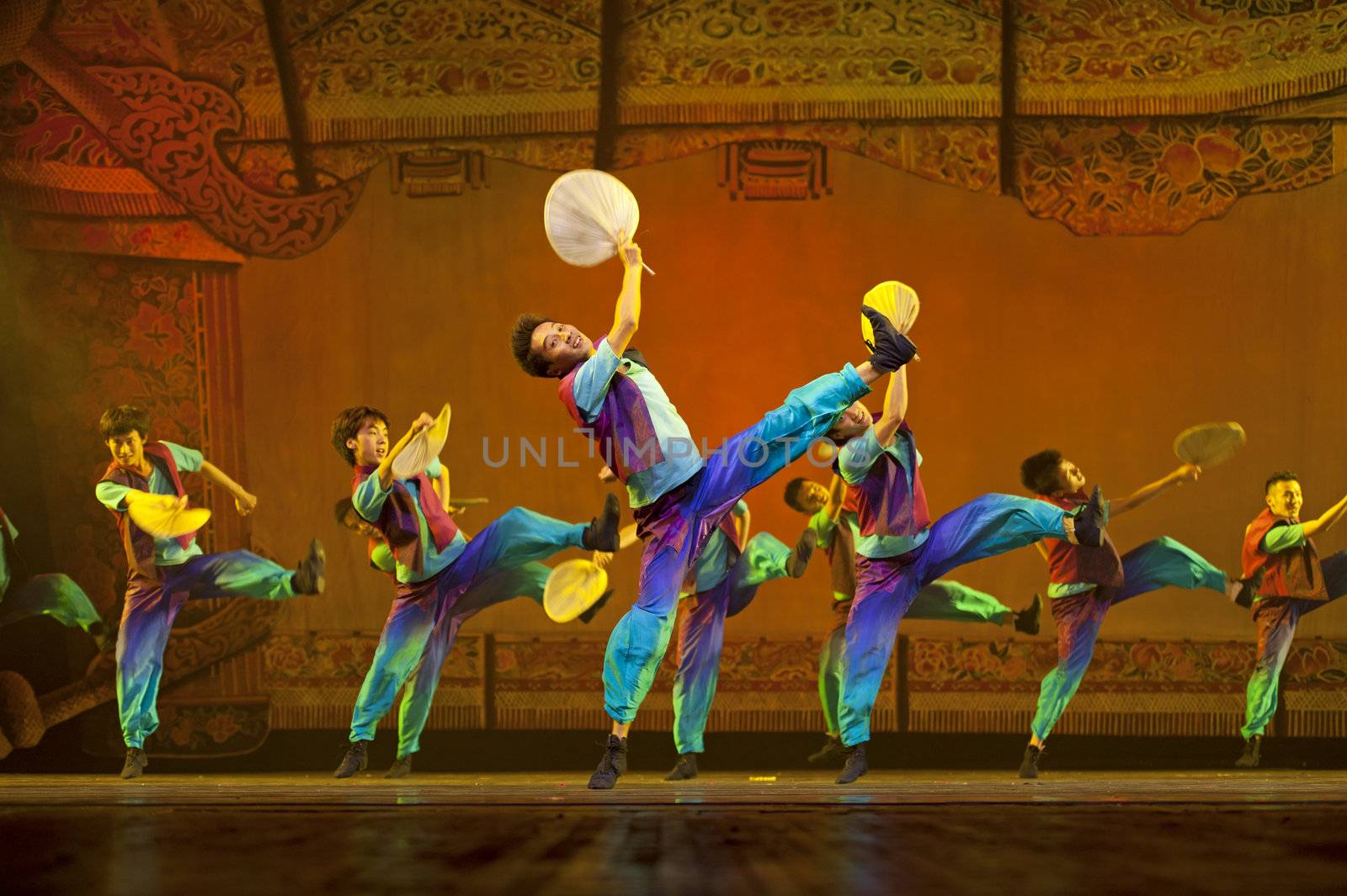 CHENGDU - OCT 17: Chinese national dancers perform folk dance on stage at JINCHENG theater on Oct 17, 2011 in Chengdu, China.