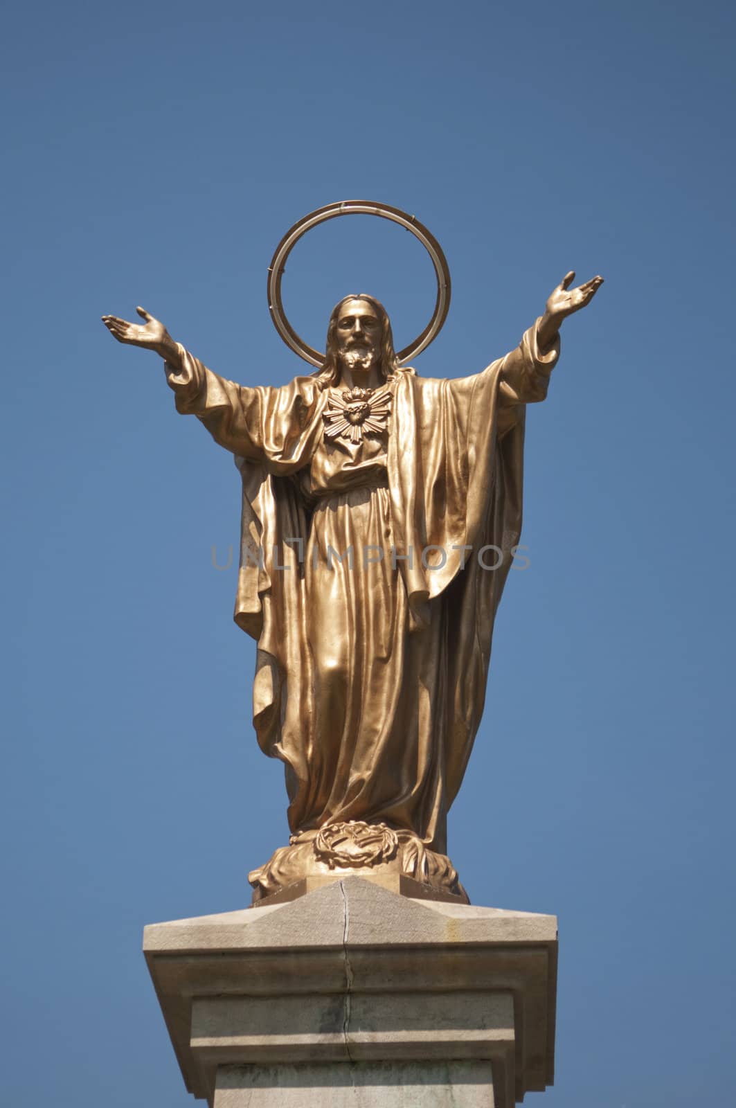Statue of Jesus Christ on the deep blue sky background with copy space