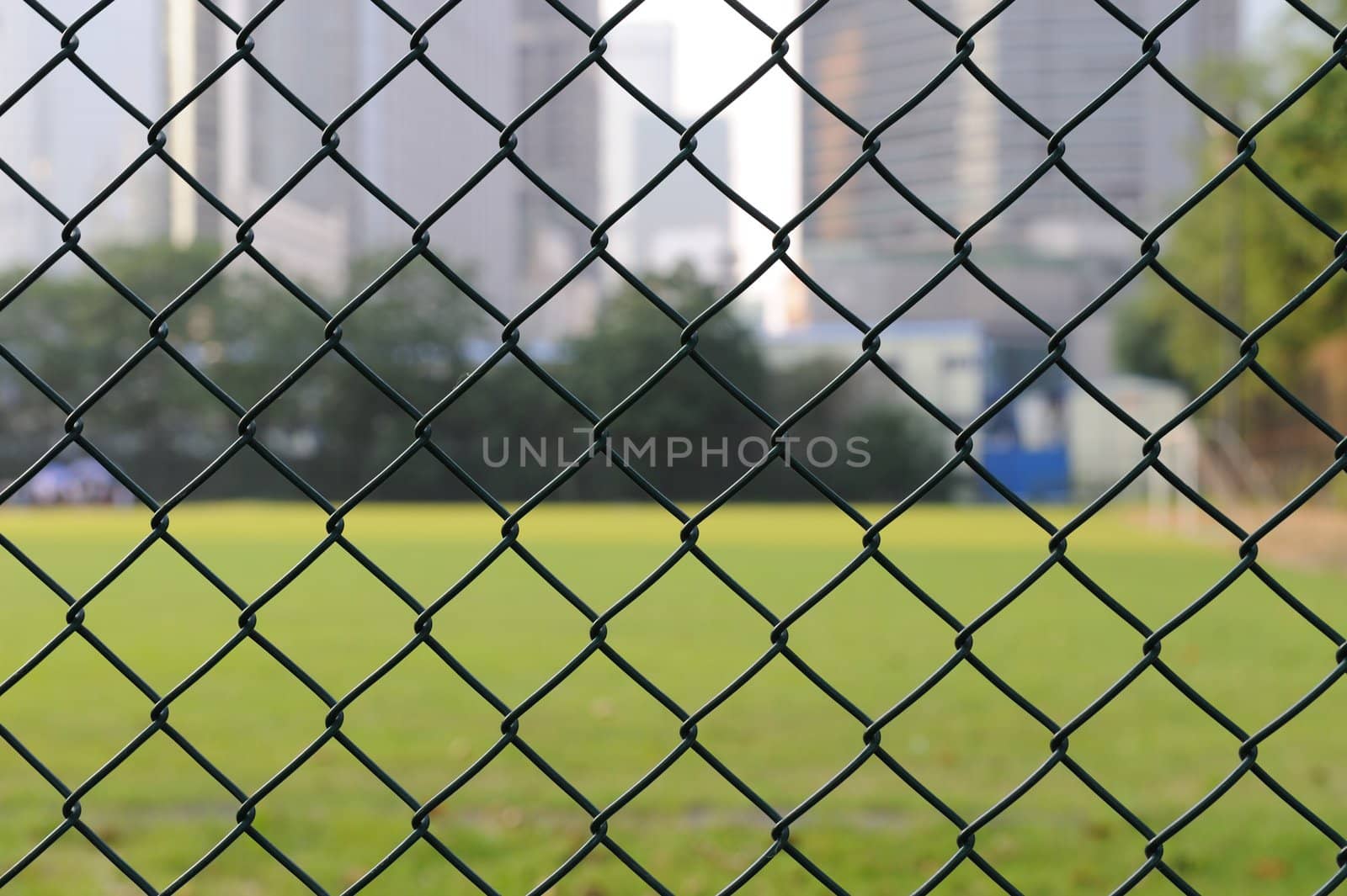 Wire netting with football field as background