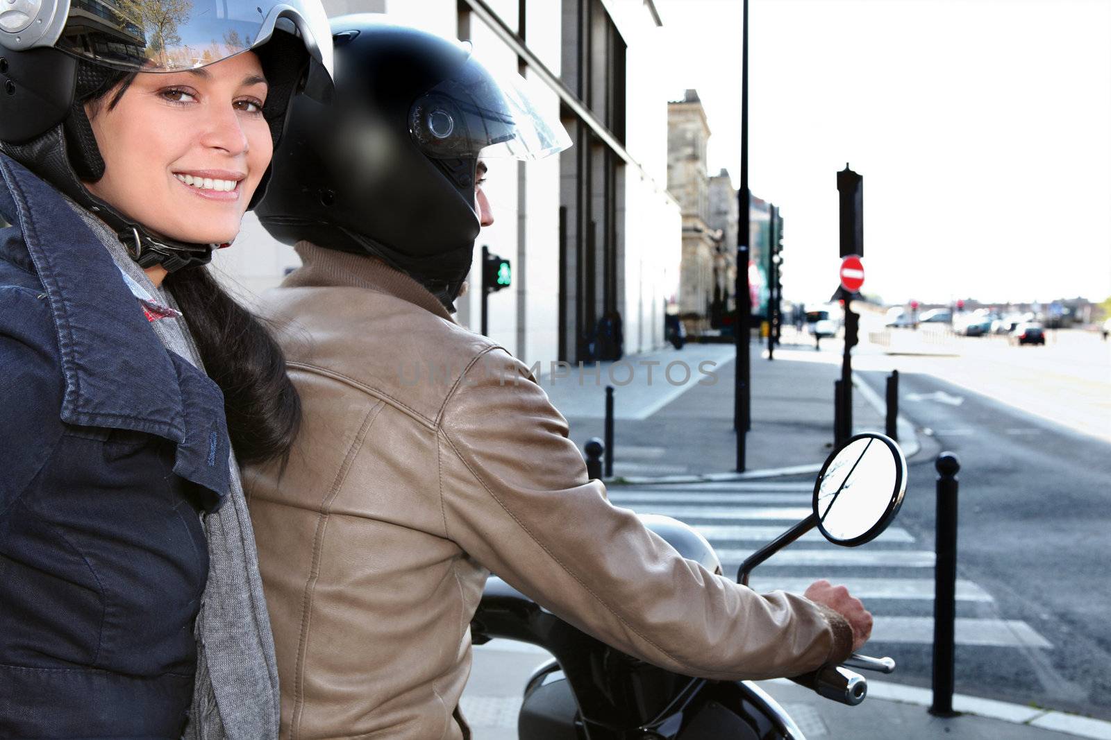 Trendy couple on a moped by phovoir