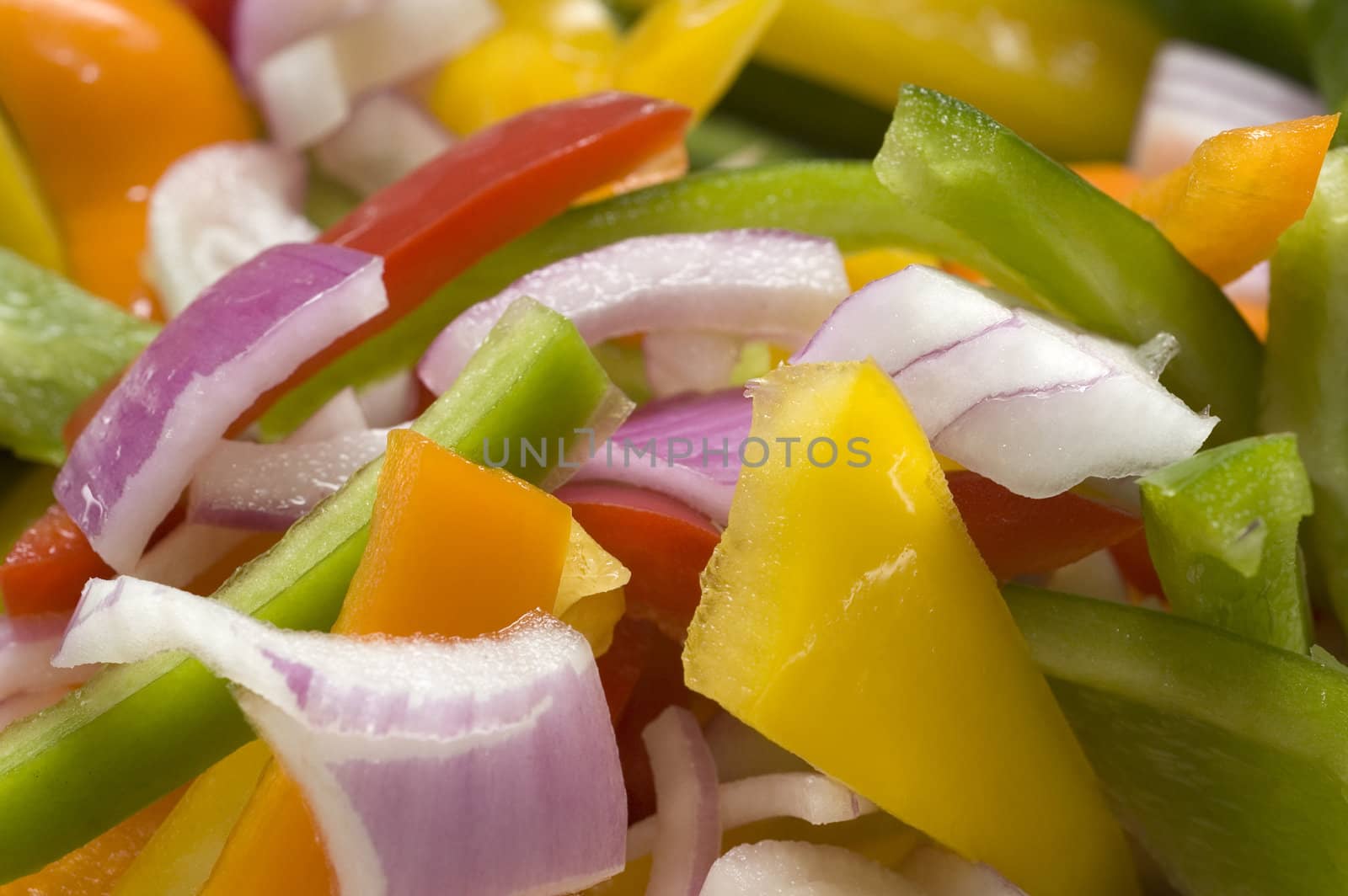 Chopped onions, green, yellow and red peppers ready for a stirfry