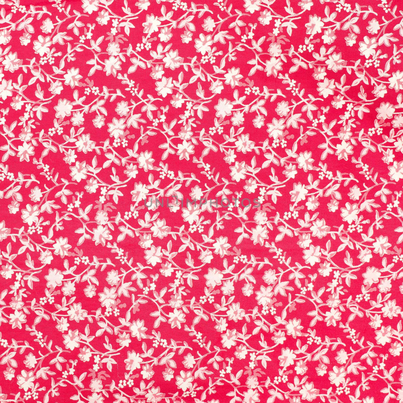 Inrticate floral pattern on red fabric as a a background