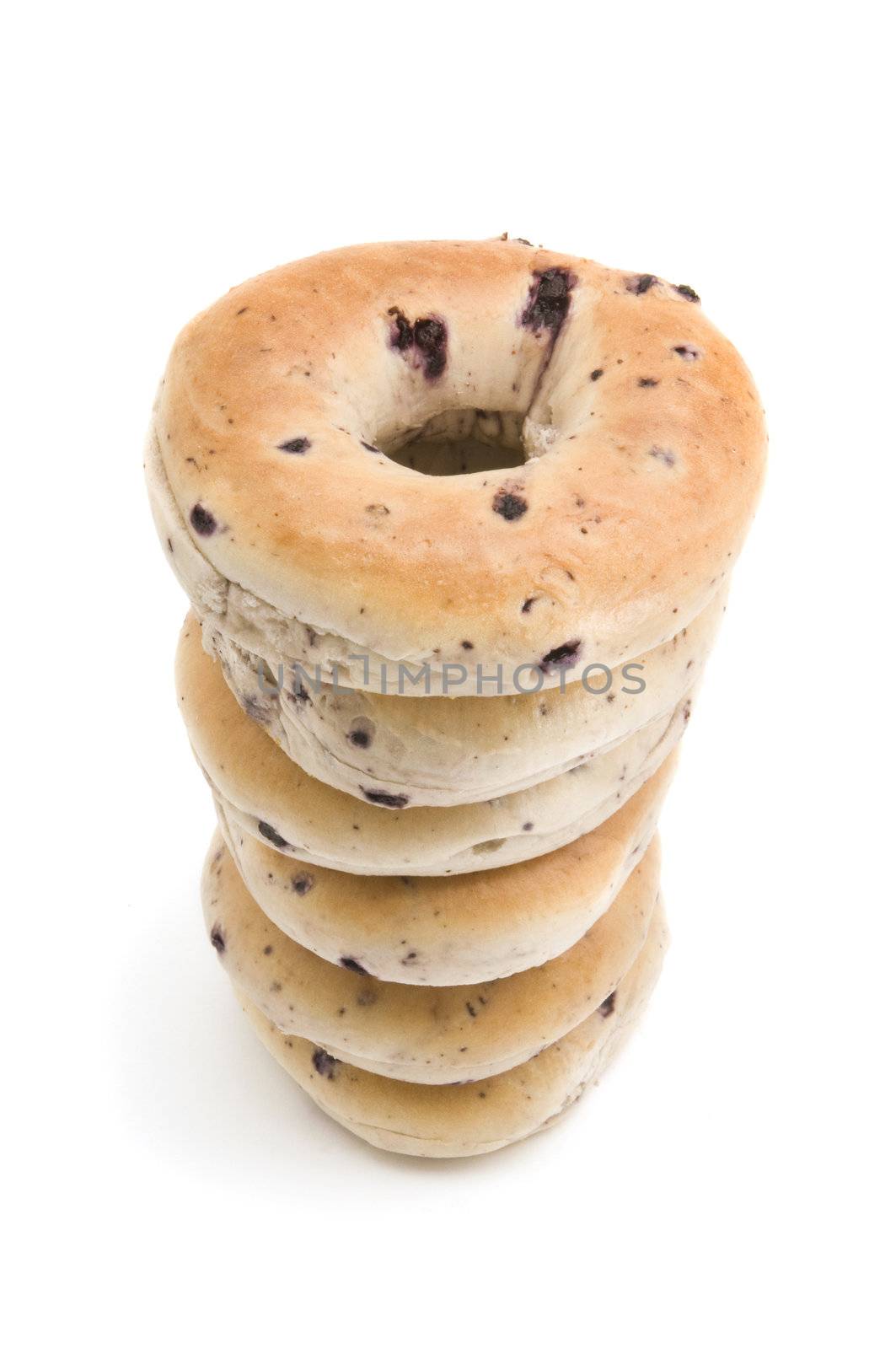 Stack of blueberry bagels on white background