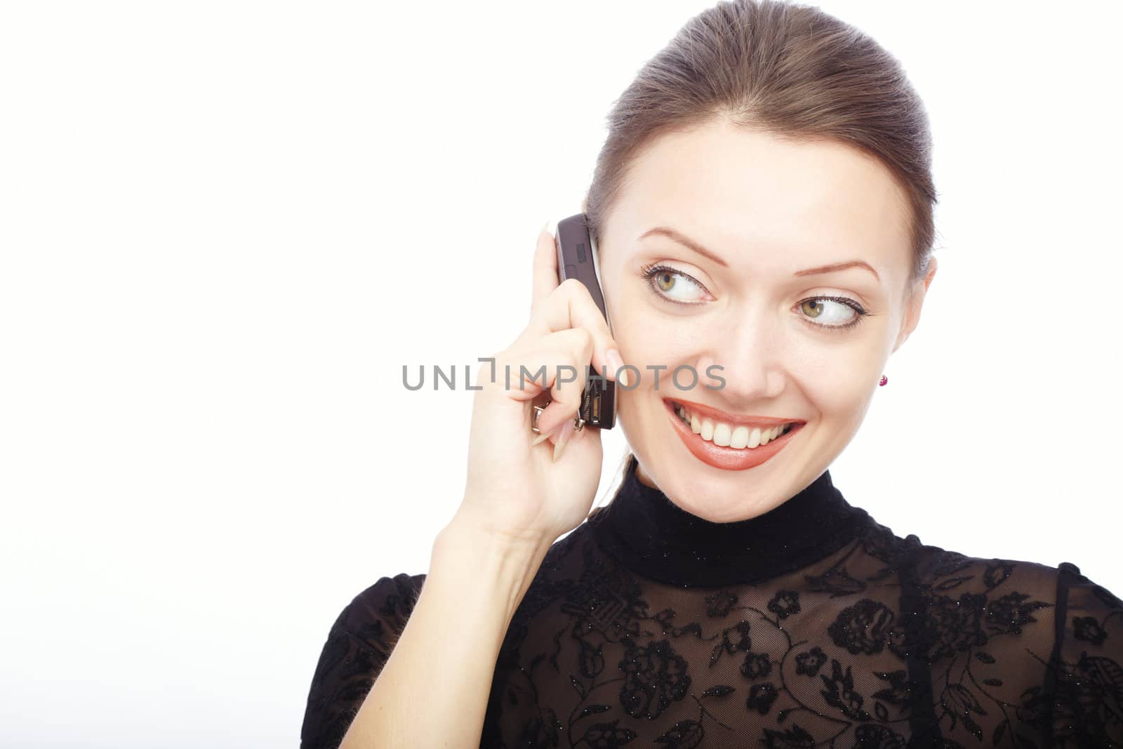 Glad smiling lady on a white background talking via cellphone