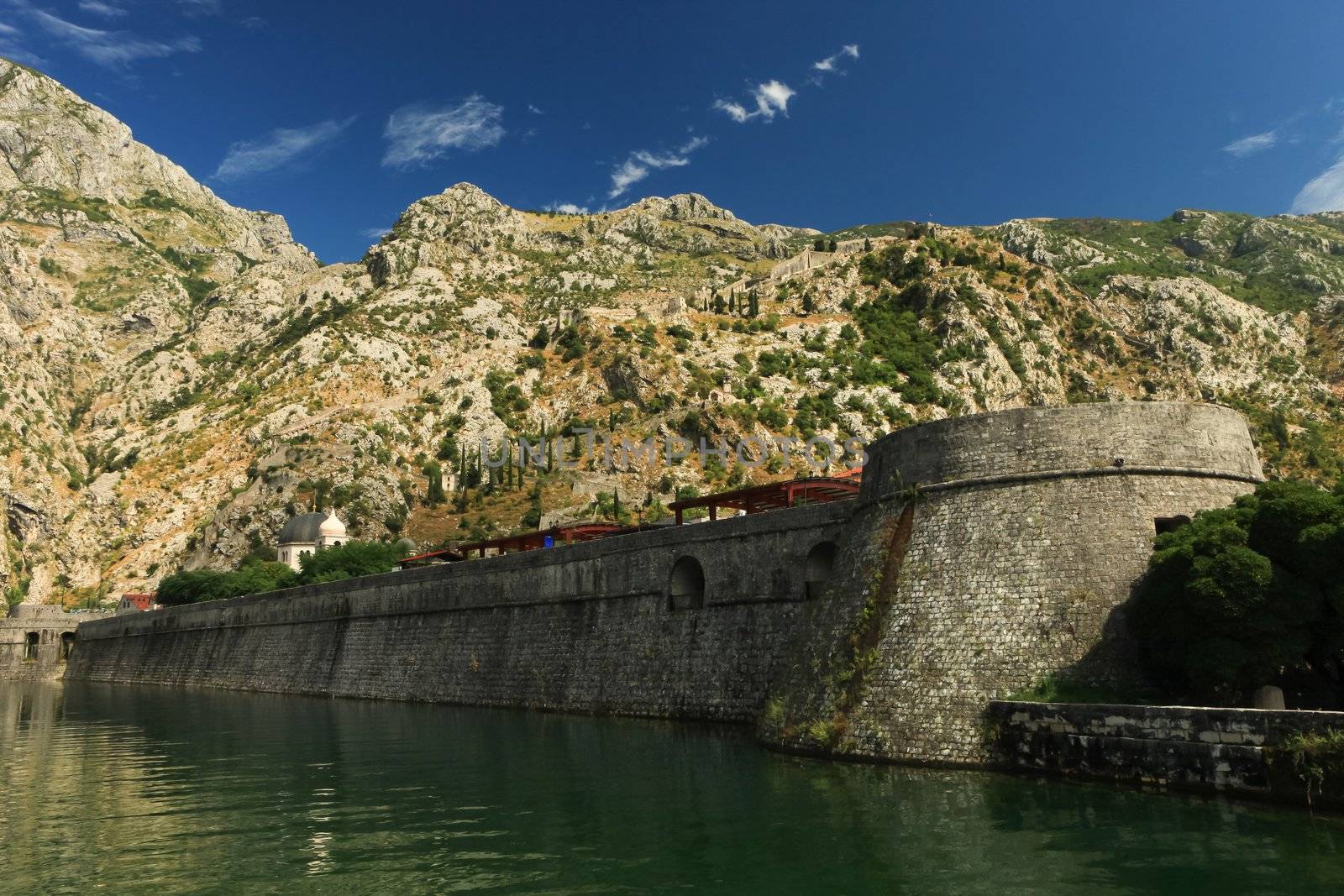 Strong fort wall along a moat in Unesco protected Kotor old town Montenegro