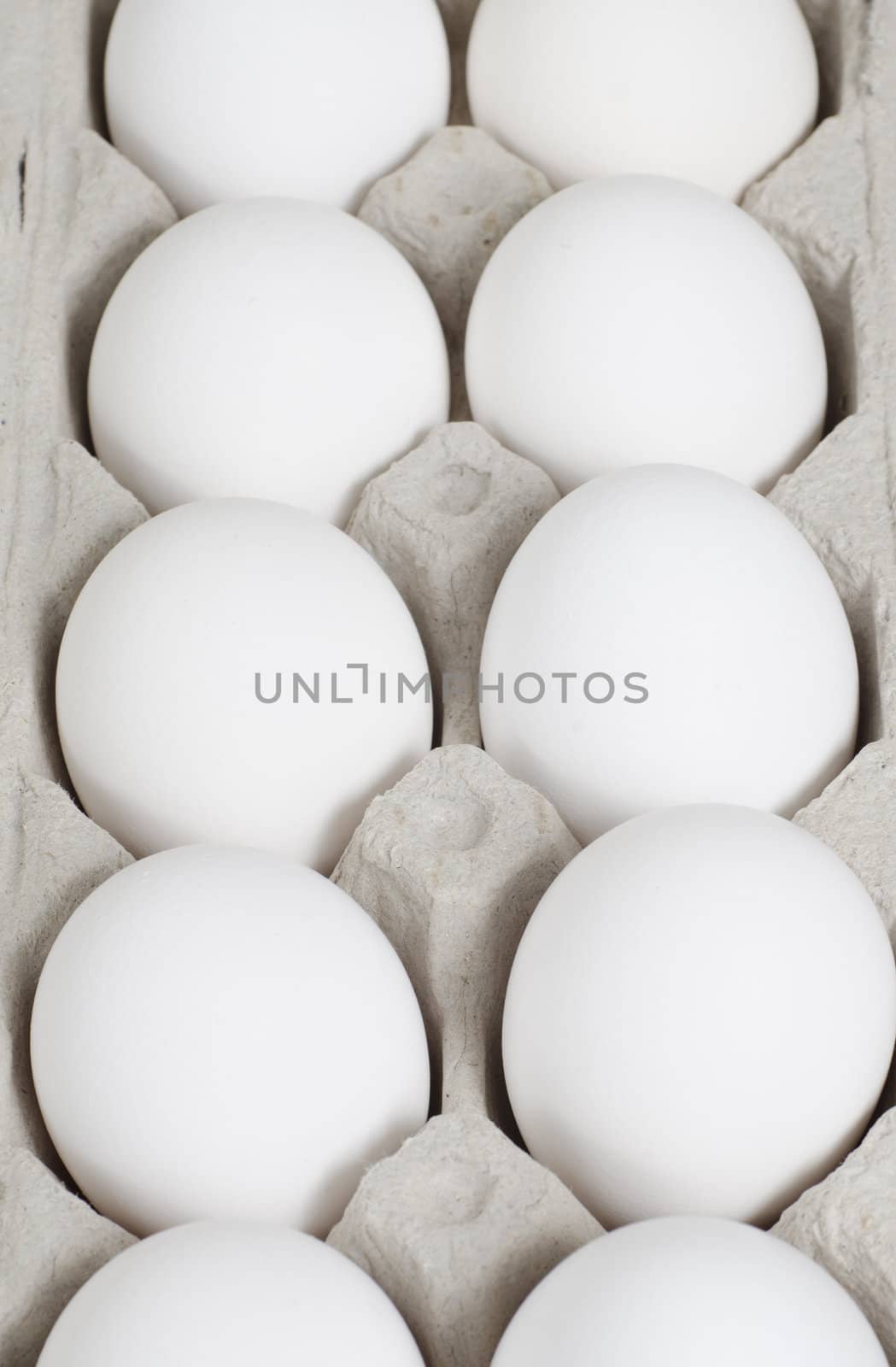 Selective focus on the middle eggs in the carton