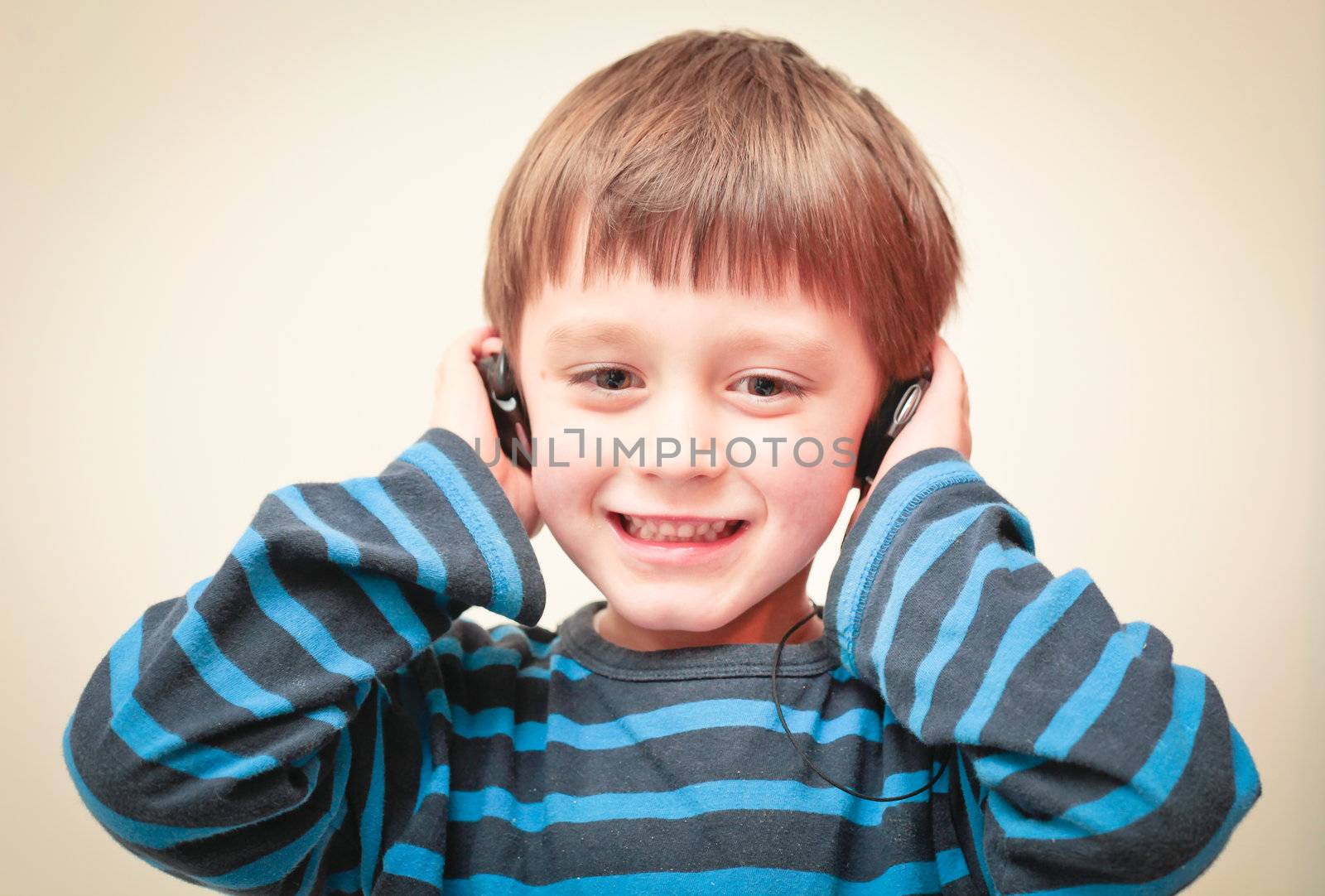 A young boy listening to music with earphones