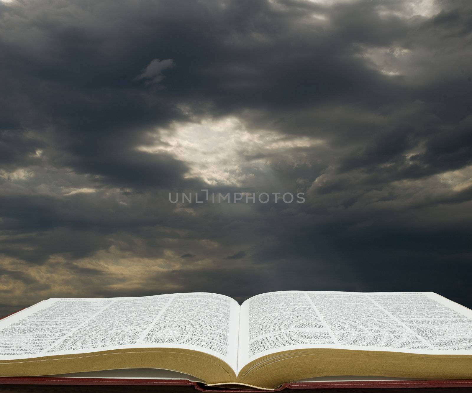 Bible open with dark sky in the background