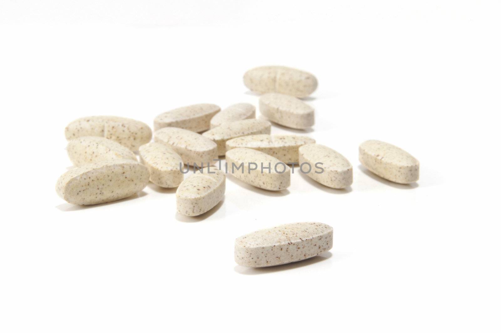 Selective focus on foreground vitamin on white background