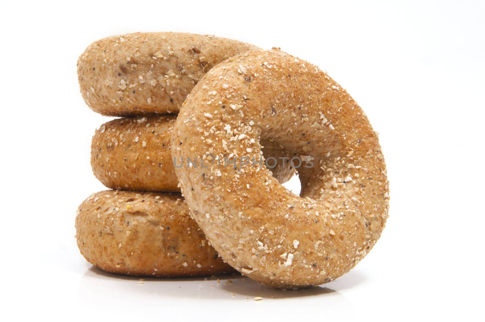 Four "Twelve Grain Bagels" with selective focus on the foreground bagel