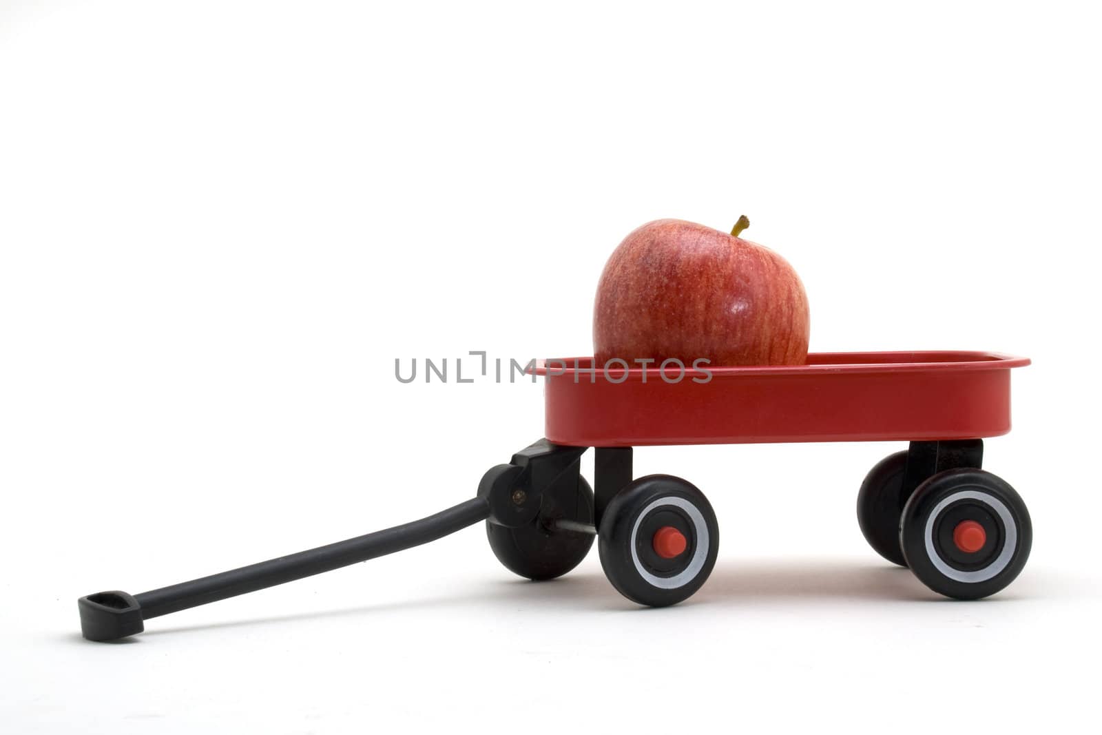 Red apple in a red wagon isolated on a white background.