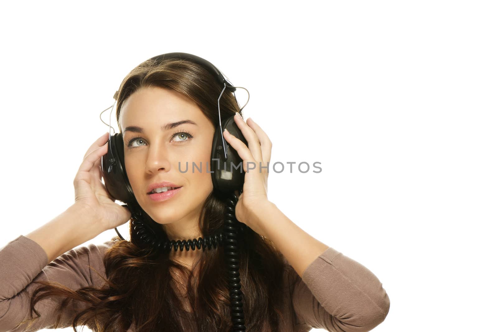 beautiful woman listening to music looking up on white background