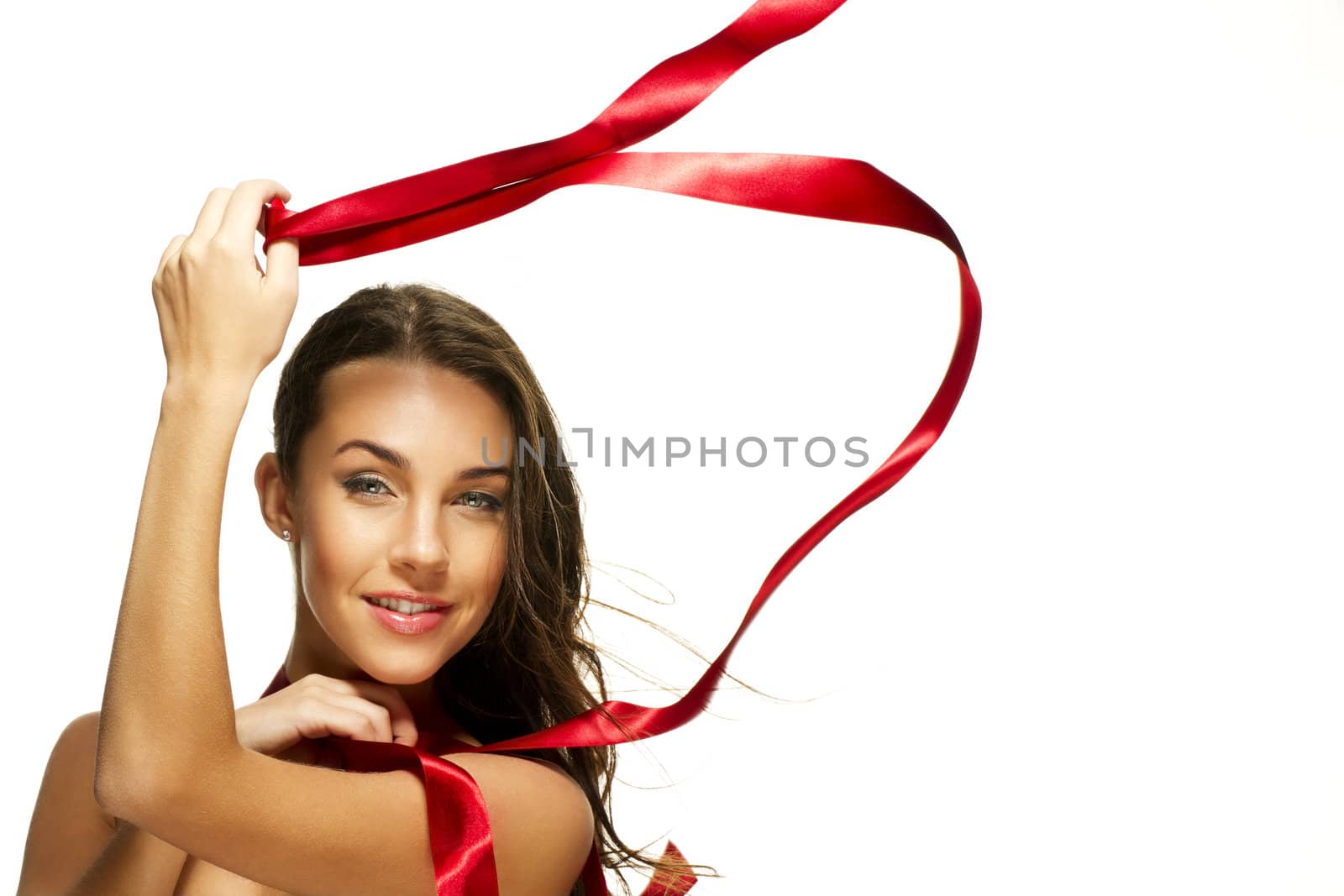 happy beautiful woman playing with a red ribbon on white background