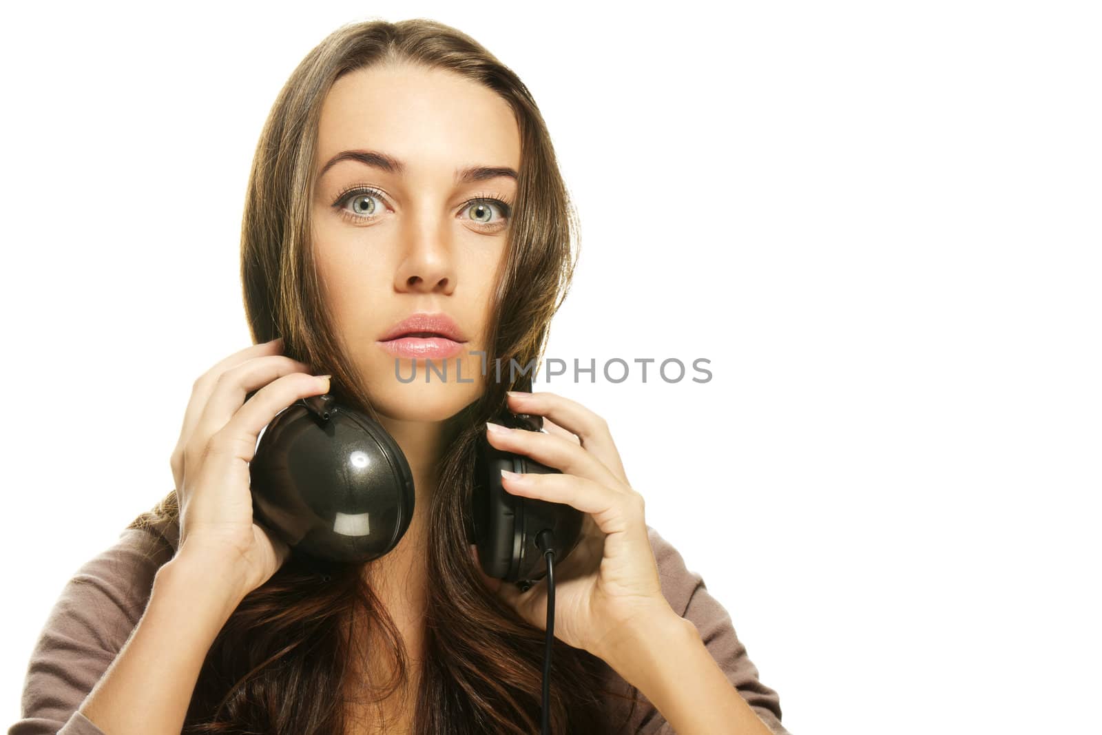 woman with headphones making big eyes on white background
