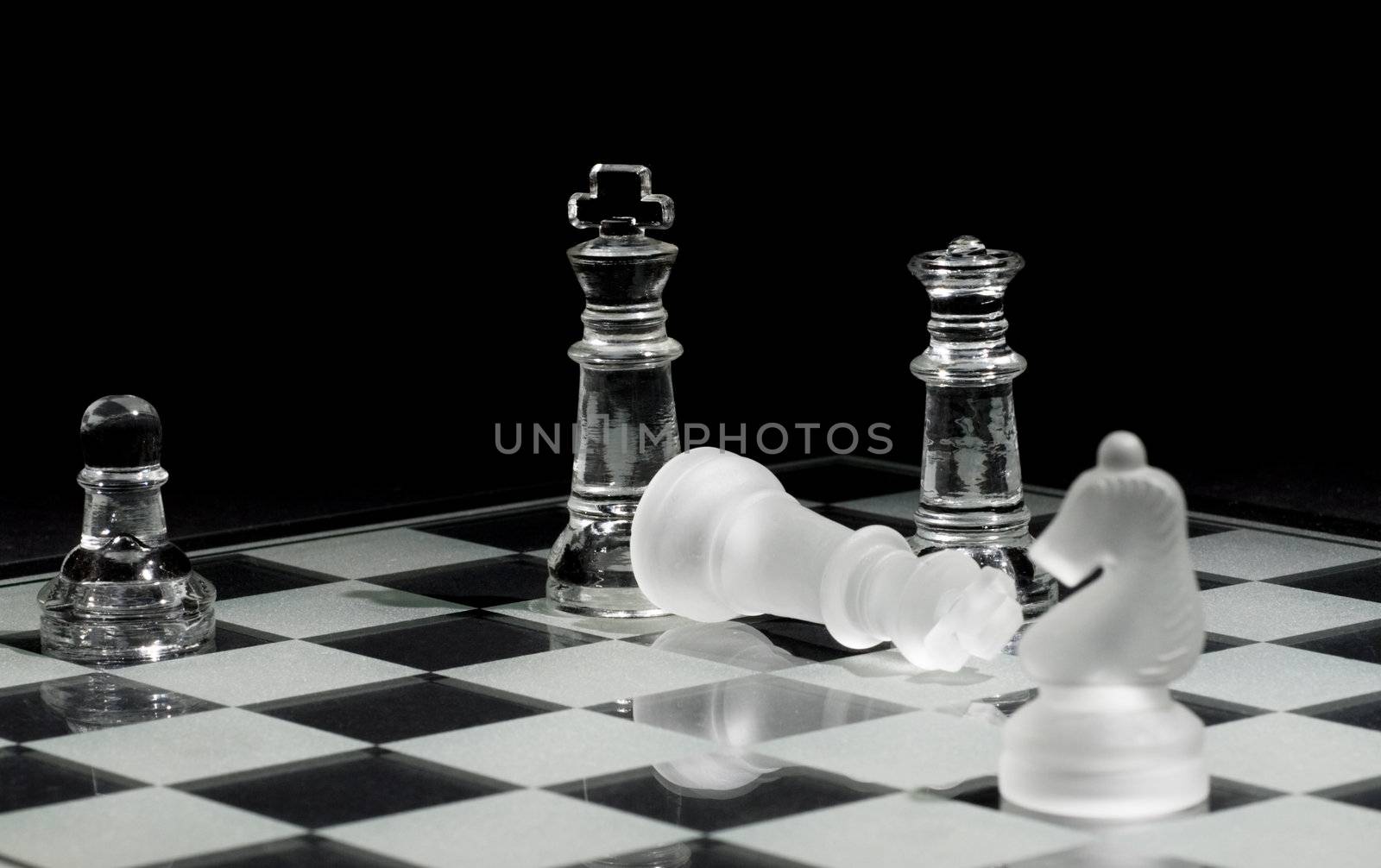Final pieces in a chess game – Checkmate. Selective focus on down king.