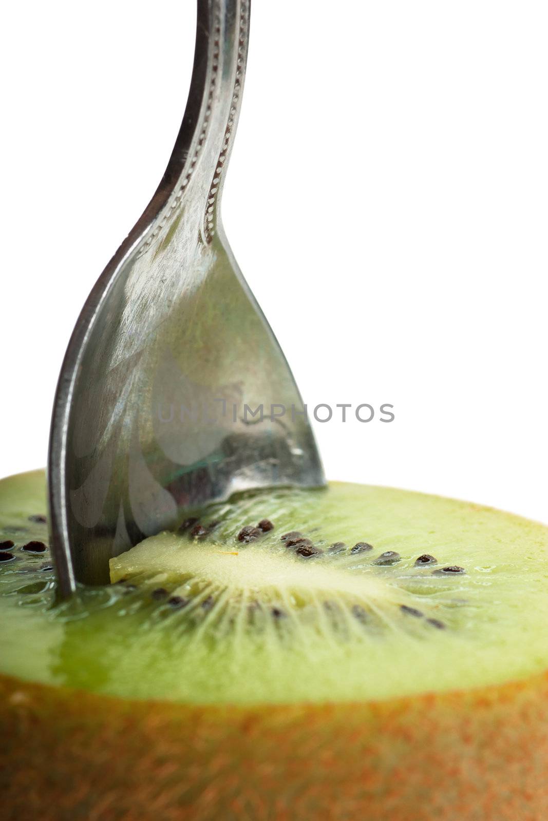 Closeup view of teaspoon in a kiwi fruit