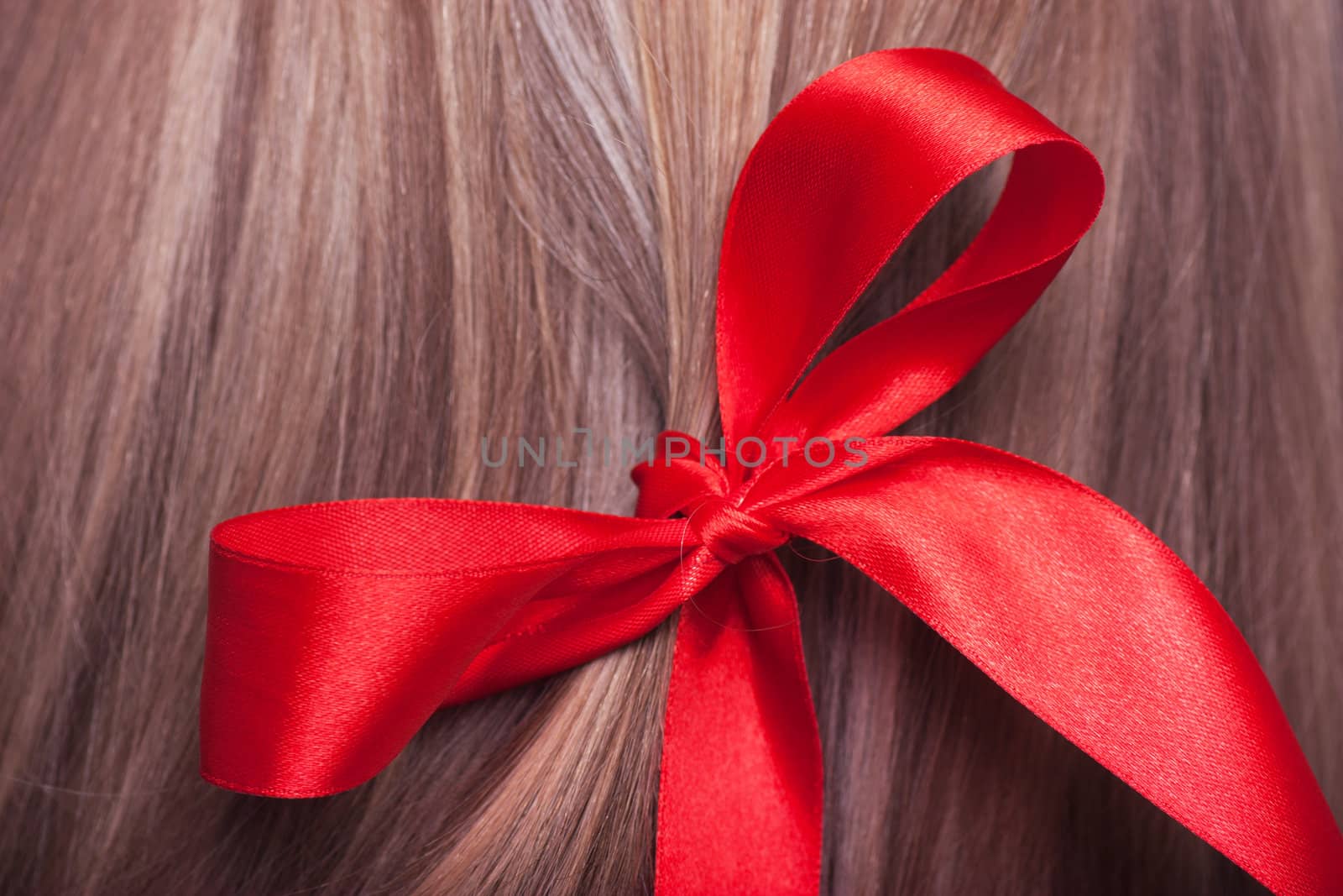 Closeup view of red bow in a womans hair