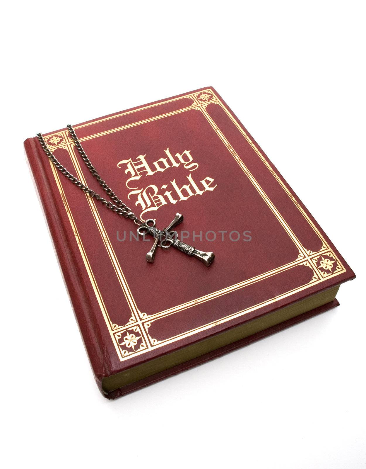Nail Cross on a red leather bible - isolated on white.