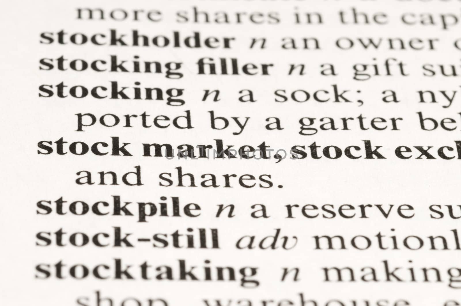 Macro image of a dictionary word "stock market" 
