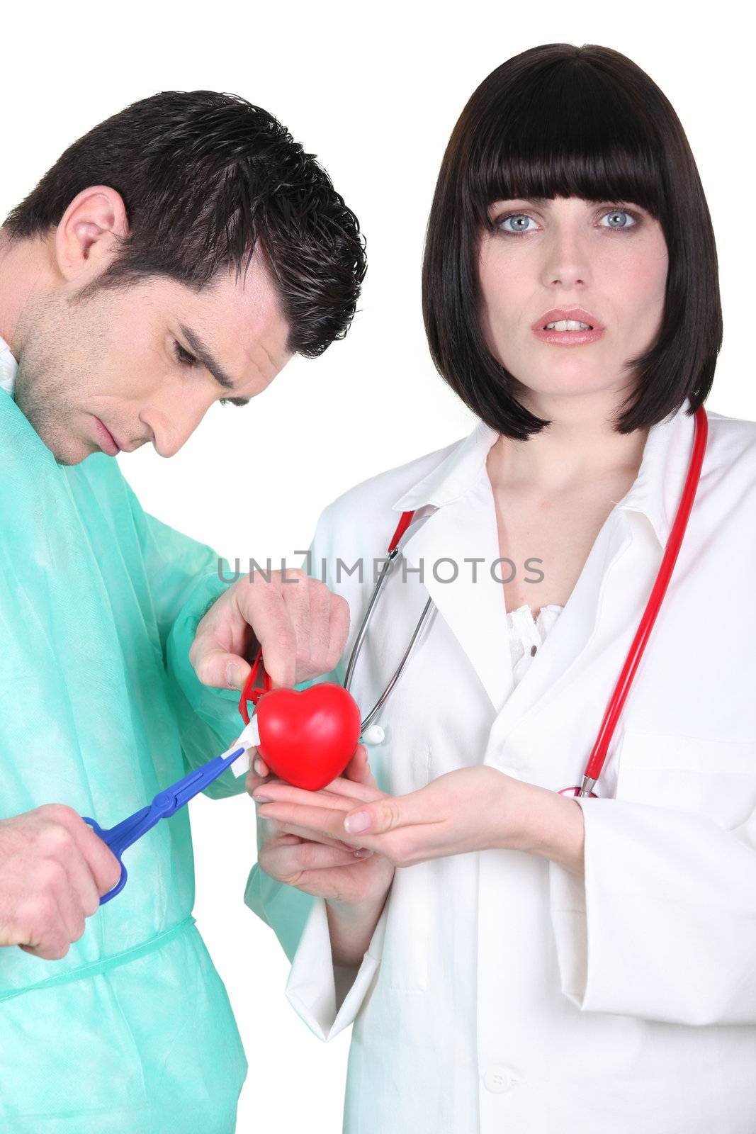 Doctors with plastic heart by phovoir