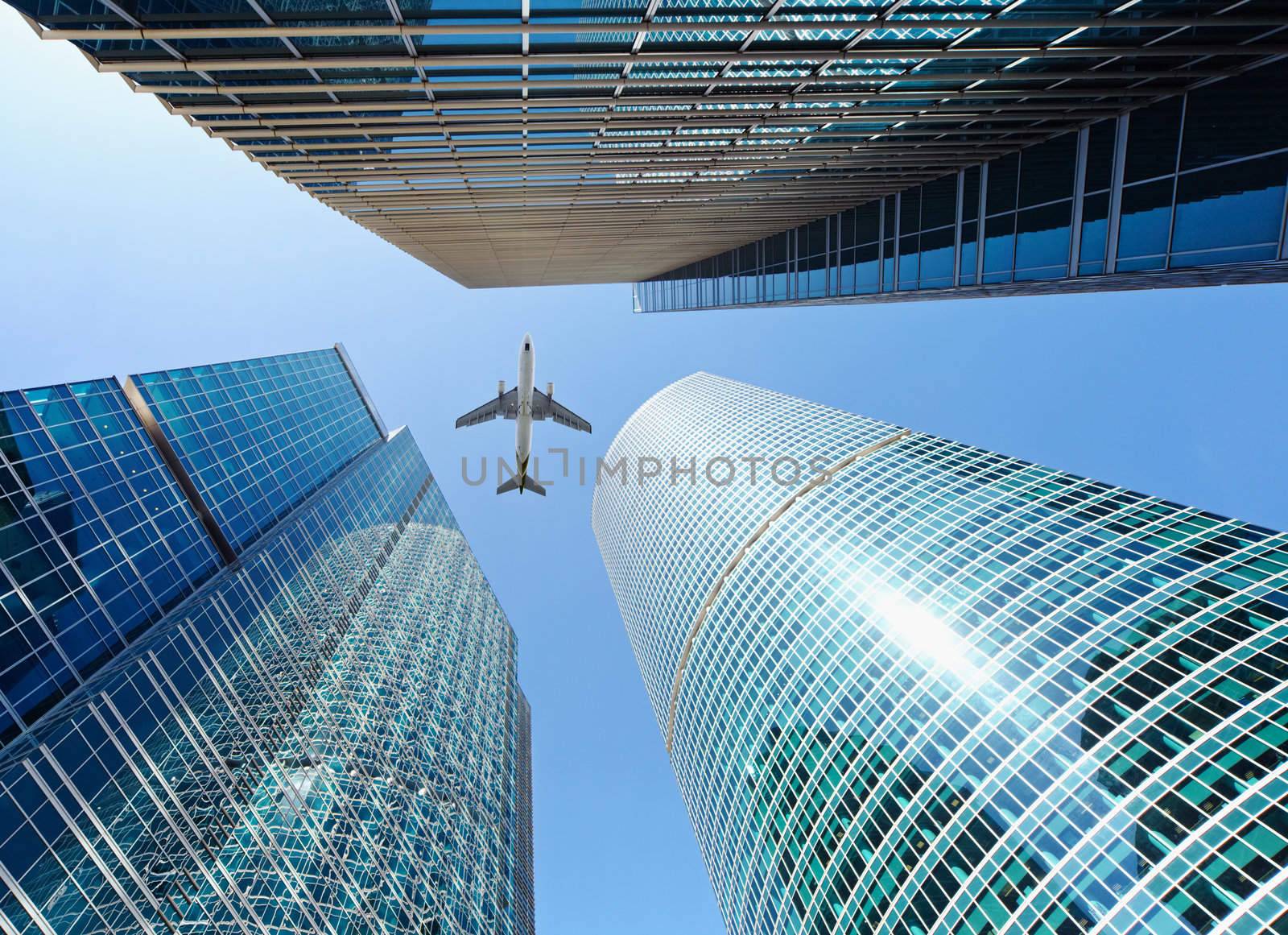 Airliner flying over high-rise buildings - skyscrapers