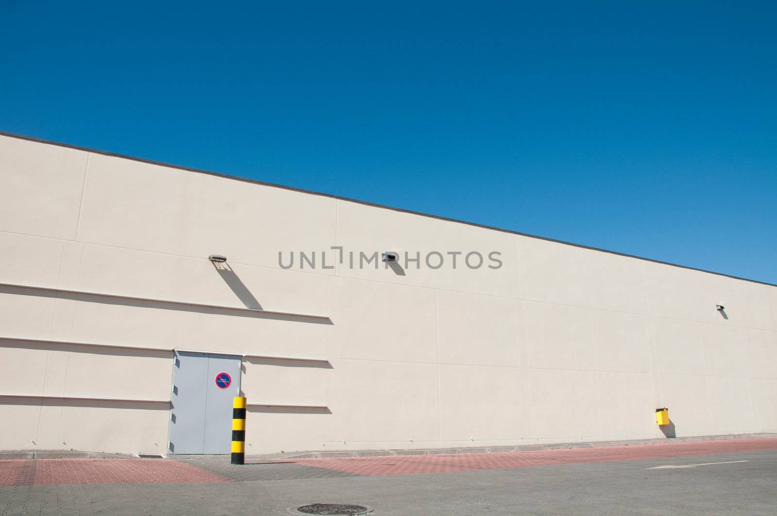 exterior view of a industrial warehouse building with a gorgeous blue sky