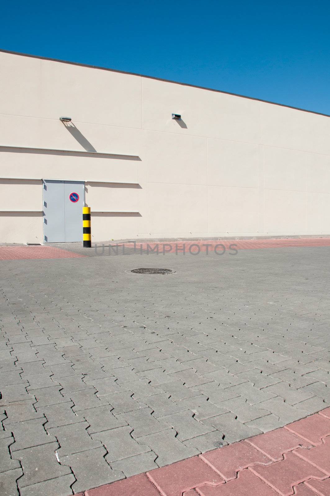 exterior view of a industrial warehouse building with a gorgeous blue sky