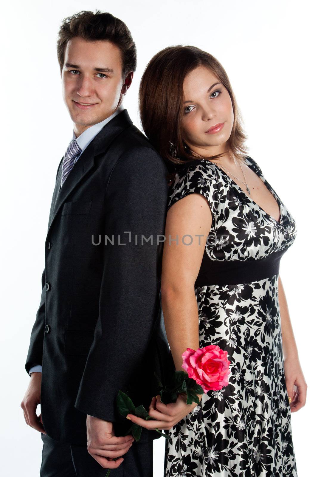 A young man gives a beautiful young woman, a flower in honor of the holiday