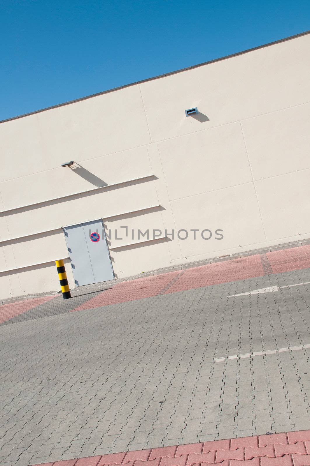 exterior view of a industrial warehouse building with a gorgeous blue sky