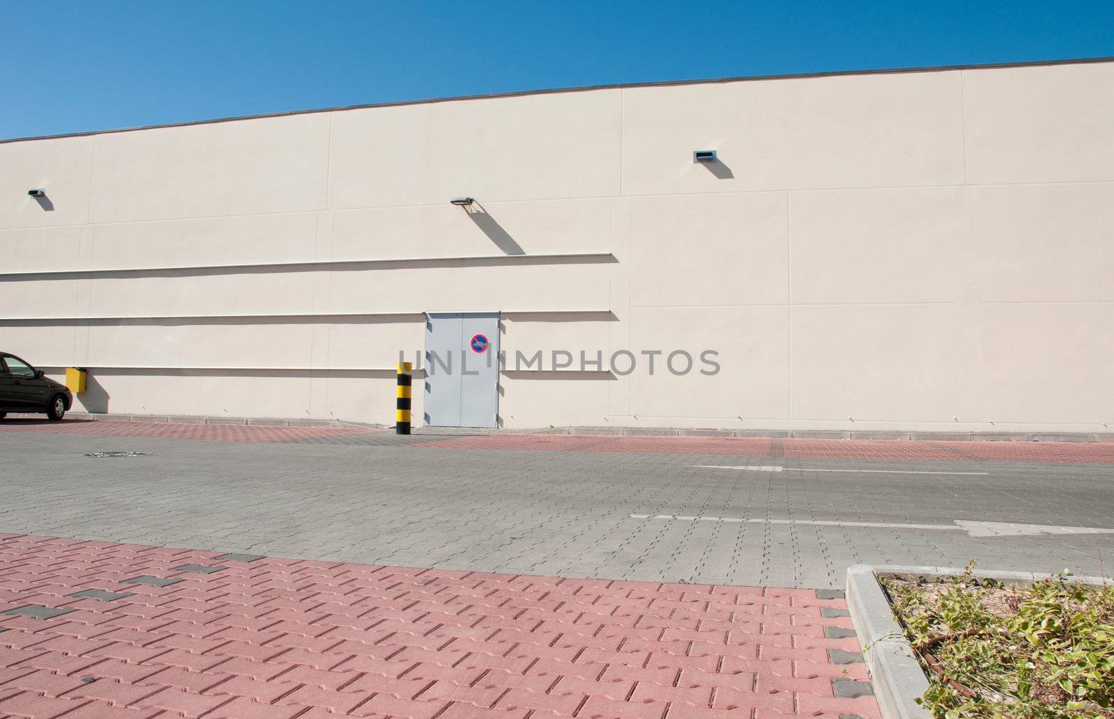 exterior view of a industrial warehouse building with a gorgeous blue sky