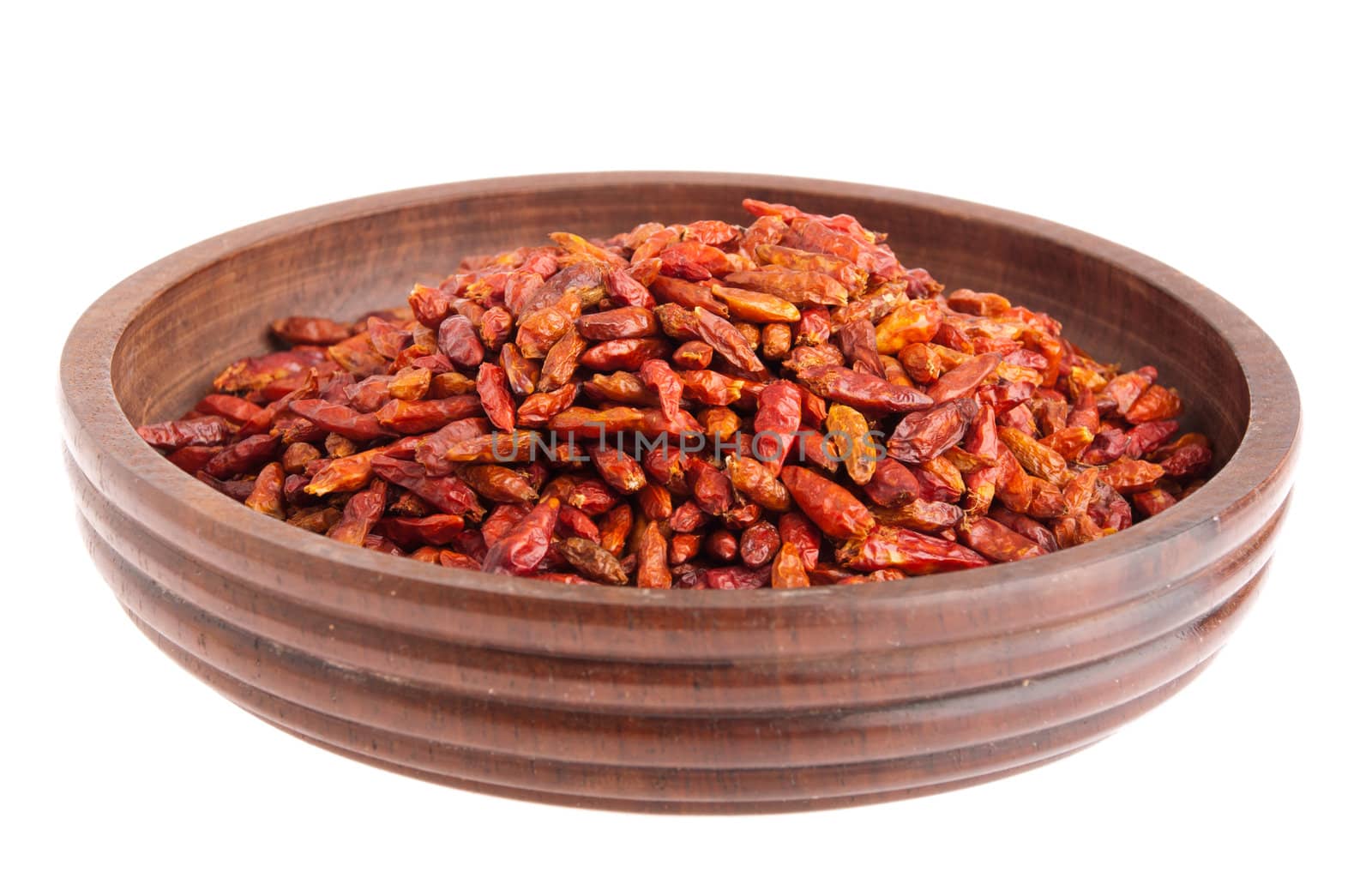 Piri Piri peppers on a vintage wooden bowl (isolated on white background)