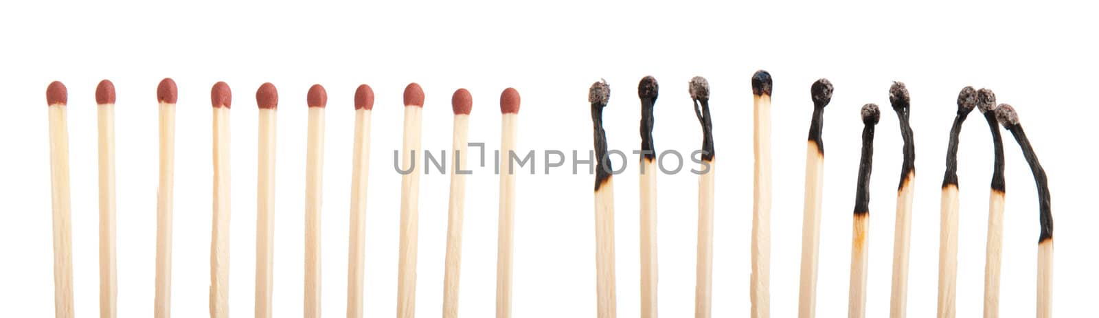 group of whole brown matches and burnt matches (isolated on a white background)