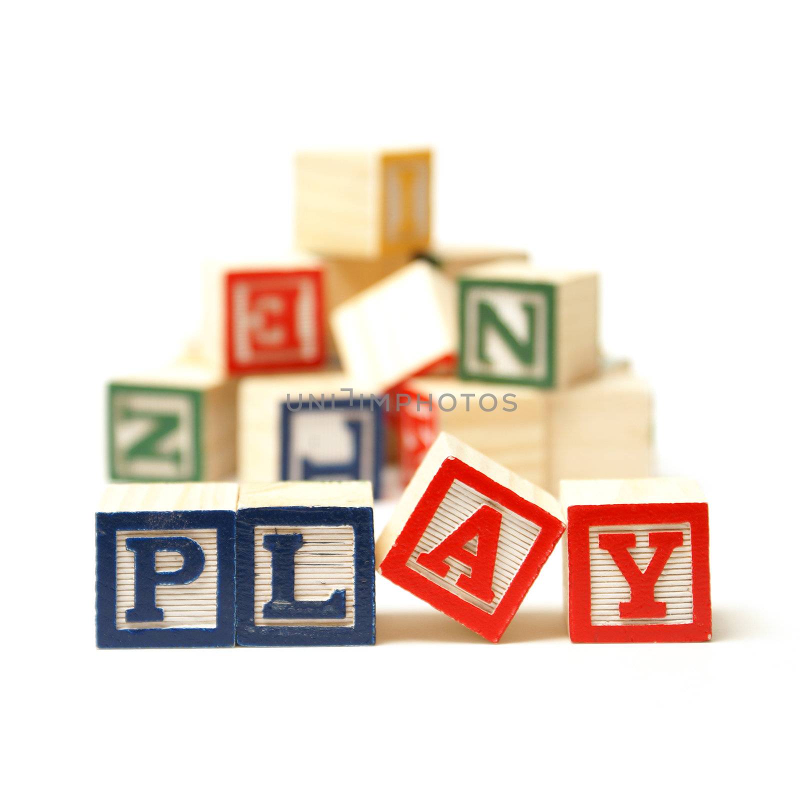 The word play has been spelled out while playing with toy blocks.