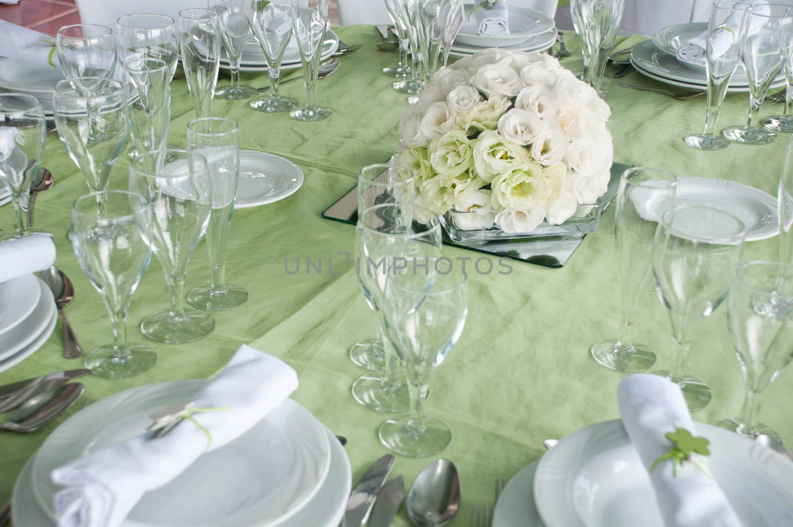 detail of a wedding table set for fine dining with a estomas arrangement