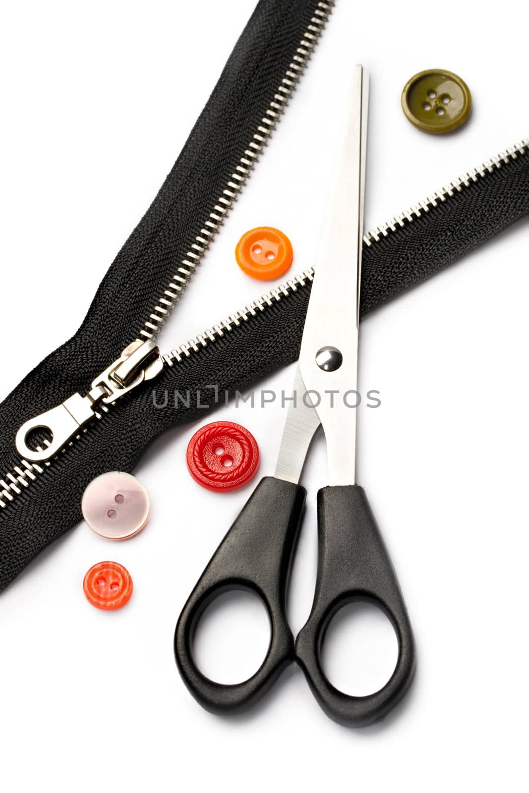 Scissors, zipper and button isolated on white by Garsya