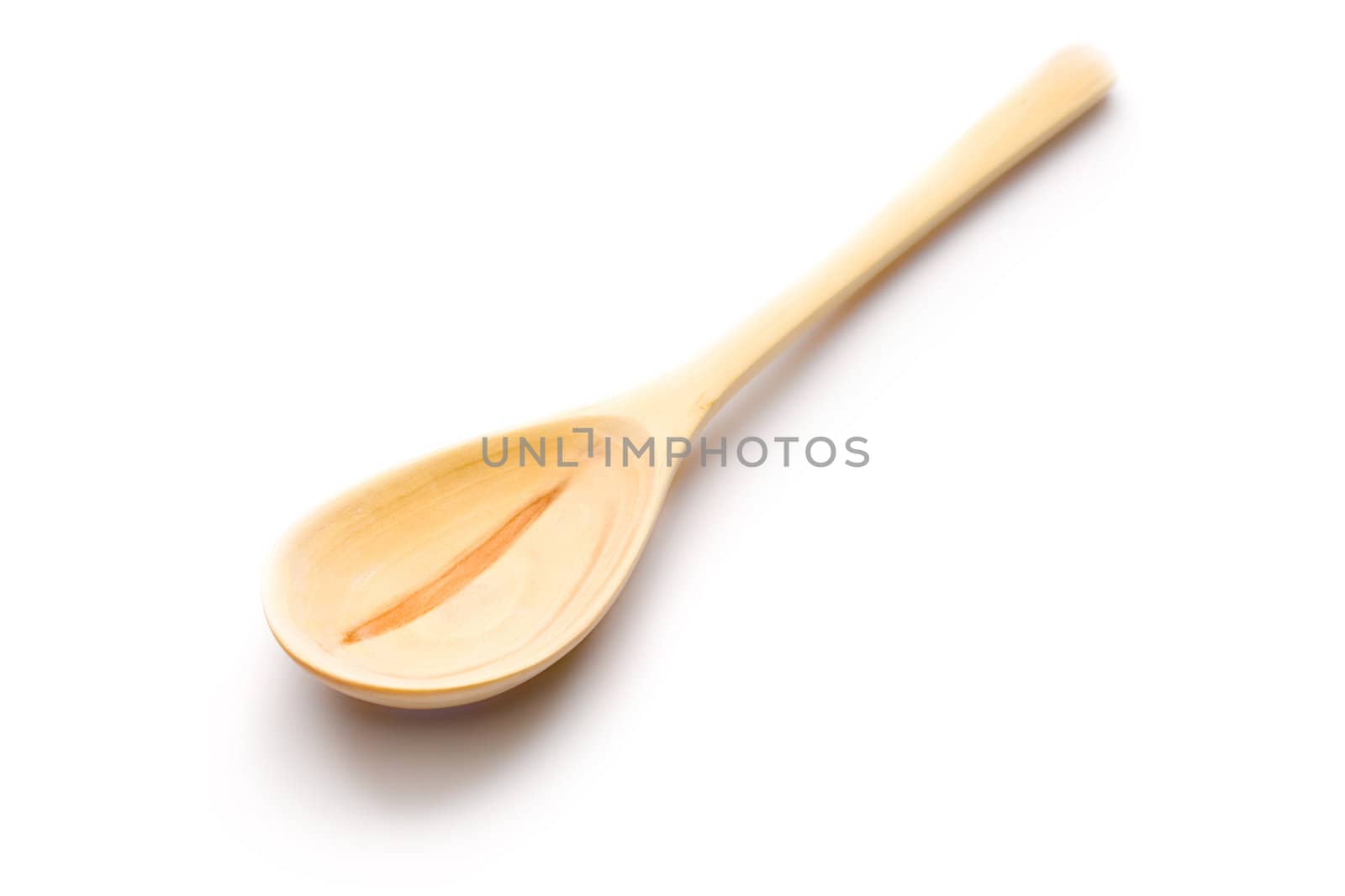 Wooden spoon isolated on white by Garsya