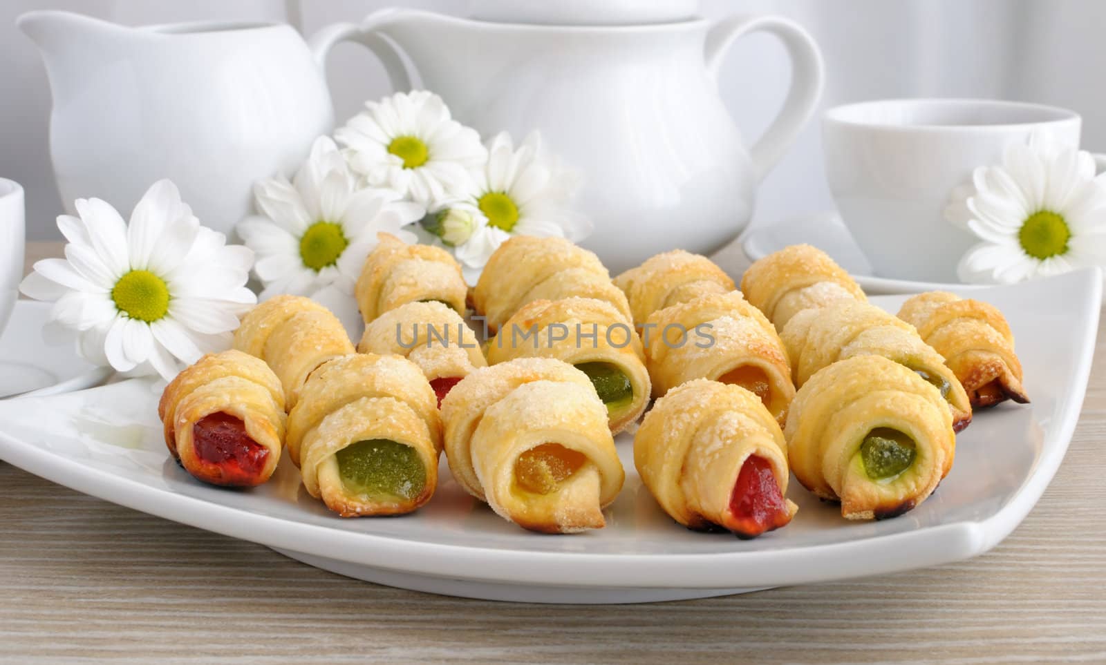 Plate with homemade croissants filled with colorful jelly