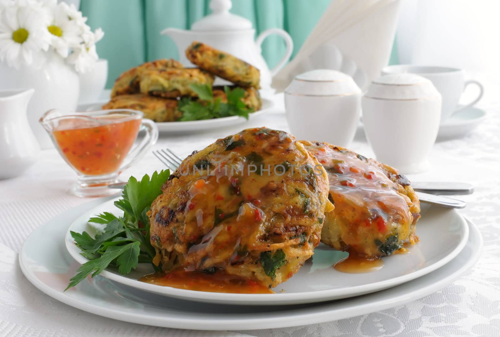 Potato pancakes with vegetables, sauce on the plate