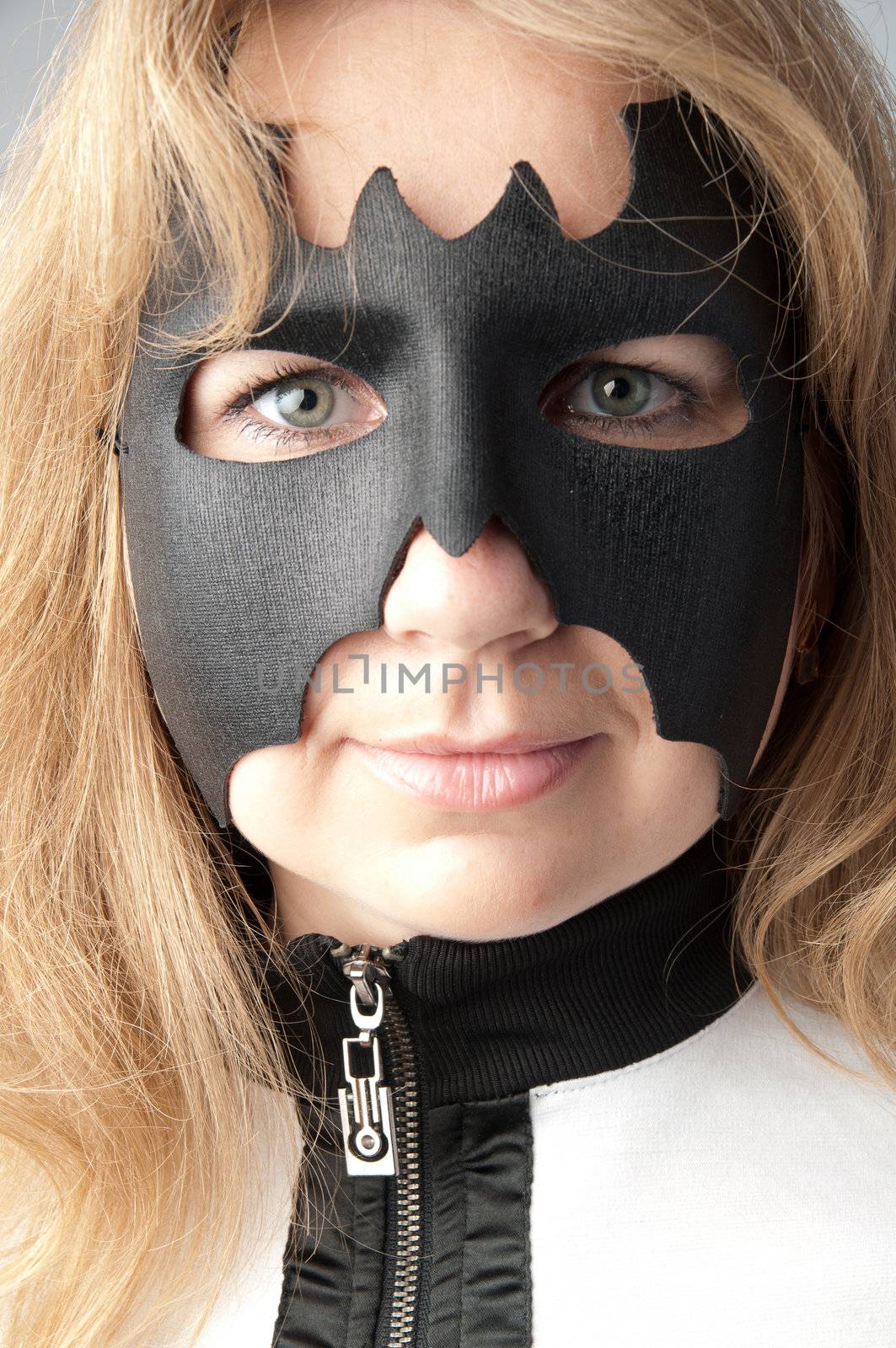 young and beautiful girl in the costume of a black bat