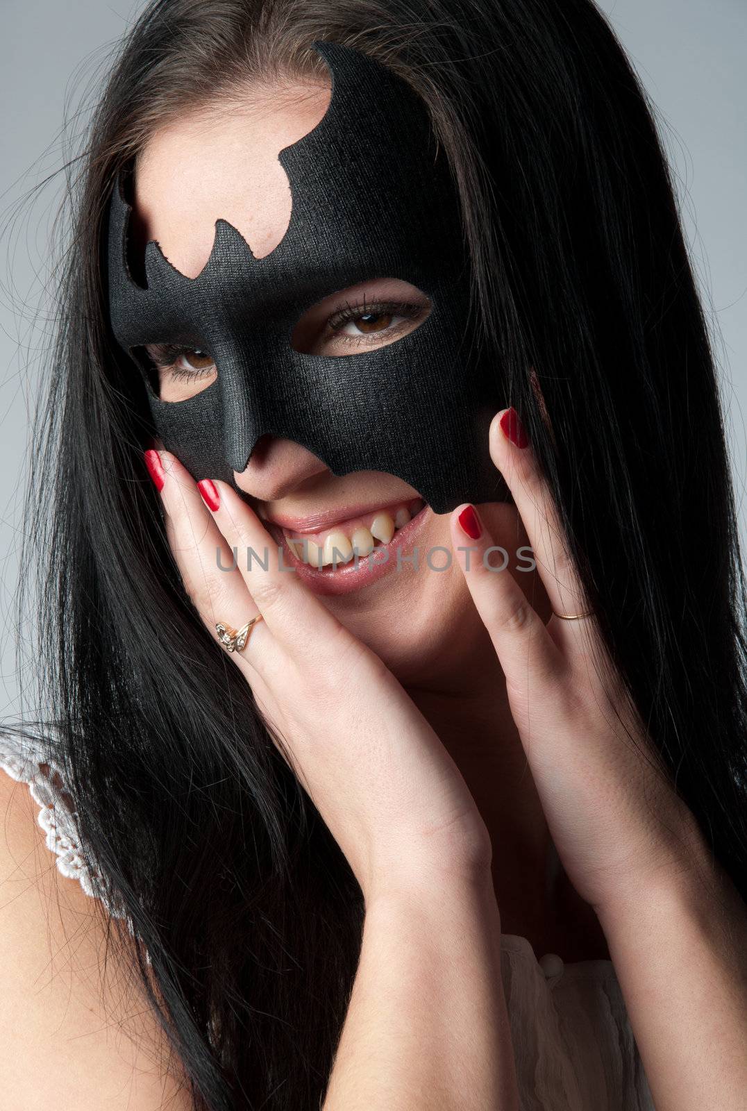 young and beautiful girl in the costume of a black bat