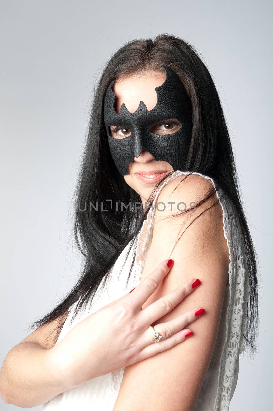 young and beautiful girl in the costume of a black bat