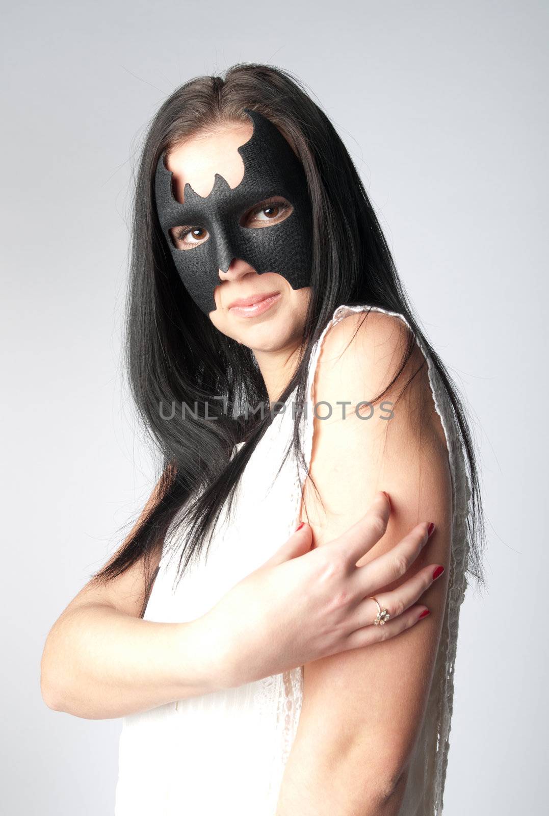 young and beautiful girl in the costume of a black bat