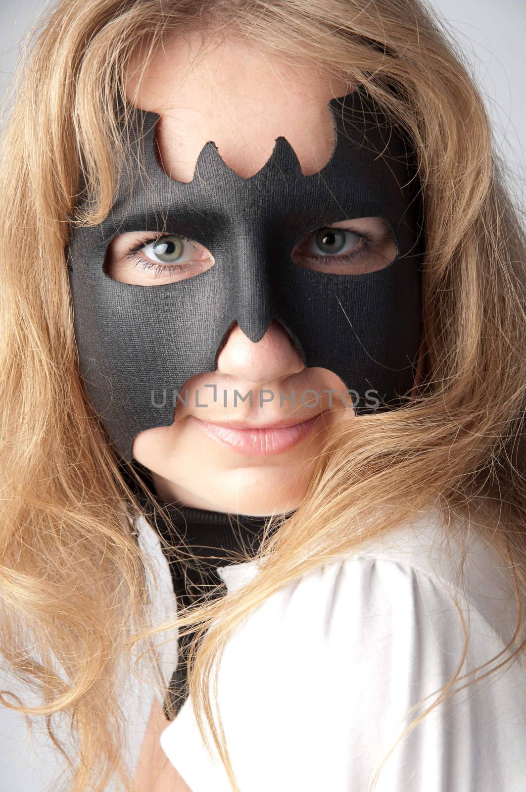 young and beautiful girl in the costume of a black bat