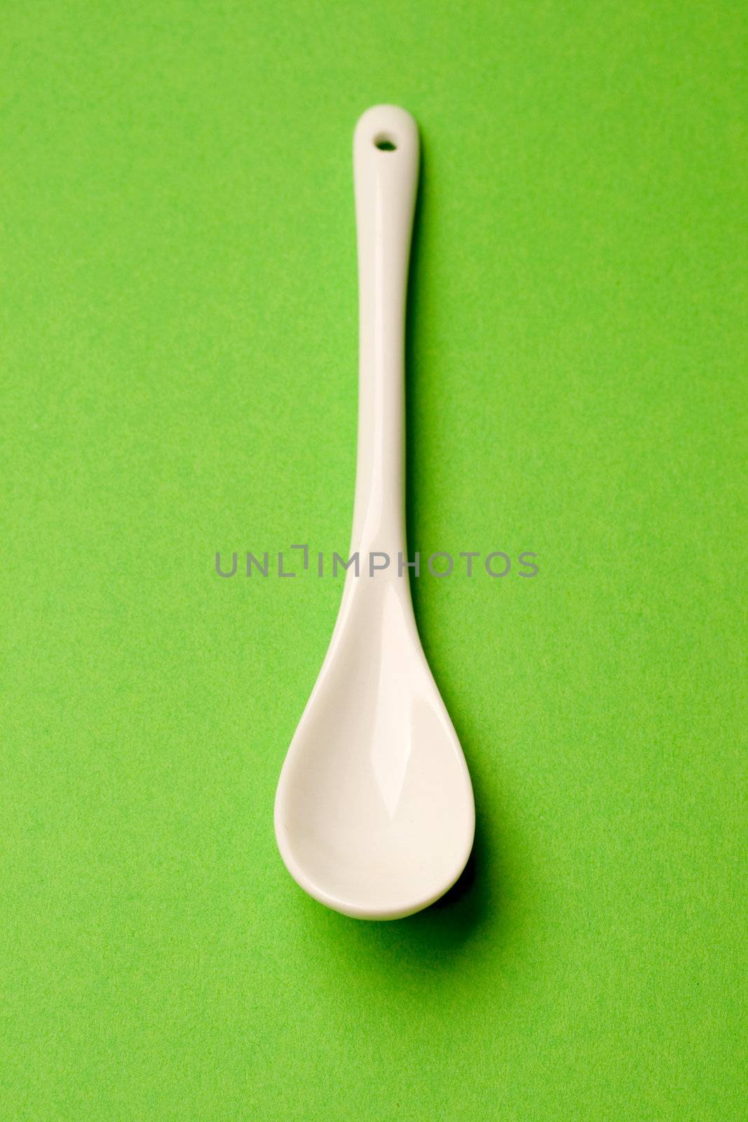 Spoon isolated on green background