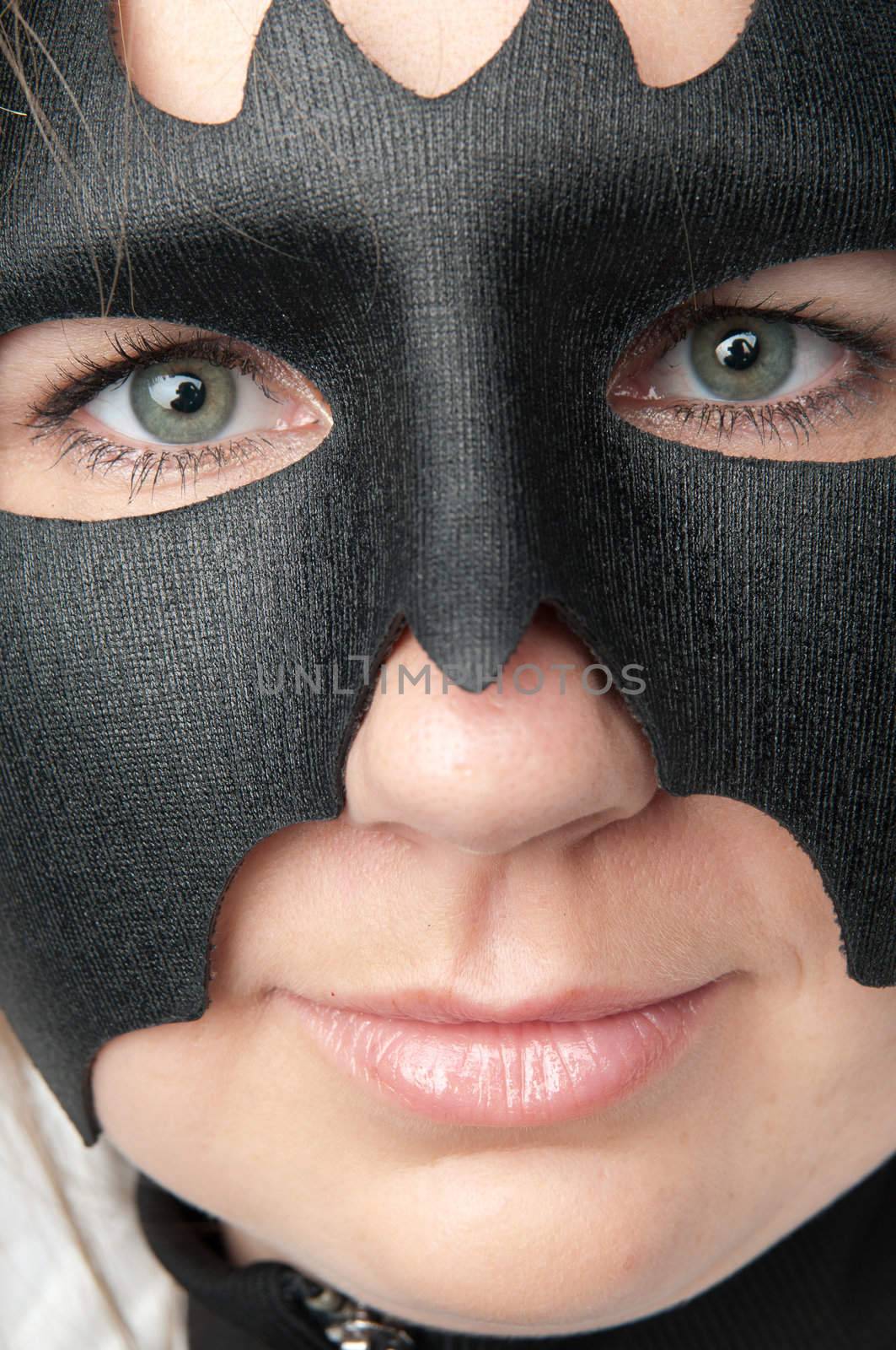 young and beautiful girl in the costume of a black bat