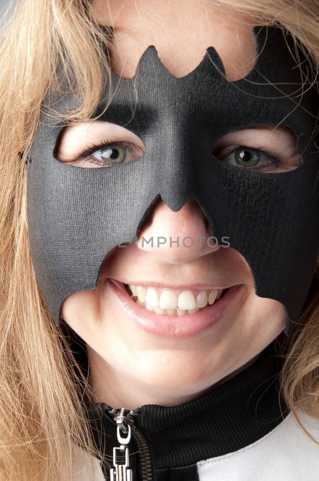 young and beautiful girl in the costume of a black bat