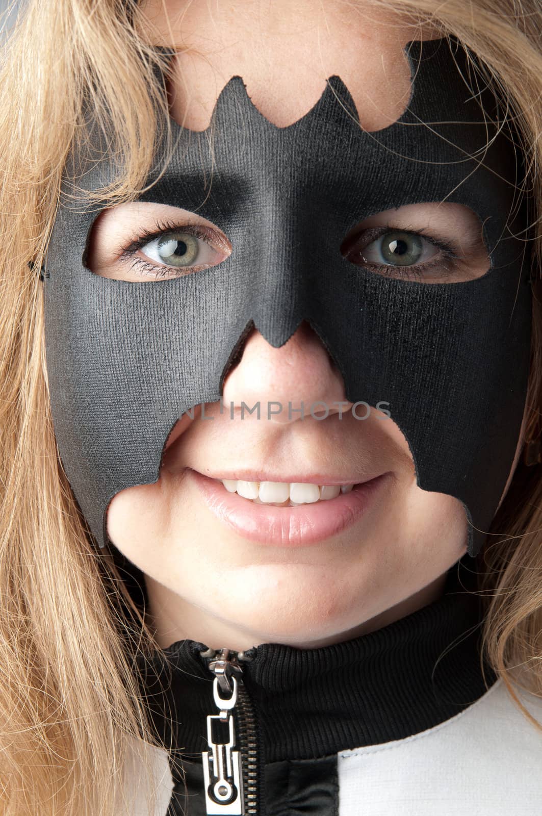 young and beautiful girl in the costume of a black bat